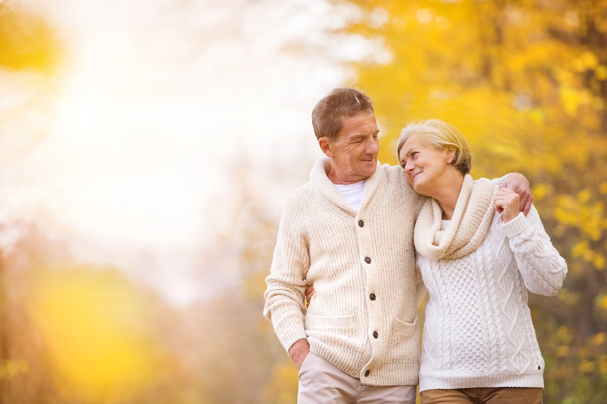 older adult couple walking peacefully during fall_Managing senior anxiety 